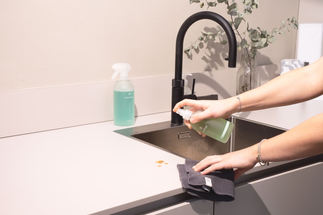 a-woman-is-cleaning-a-kitchen-sink-with-a-rag-sqomdoqb3ws